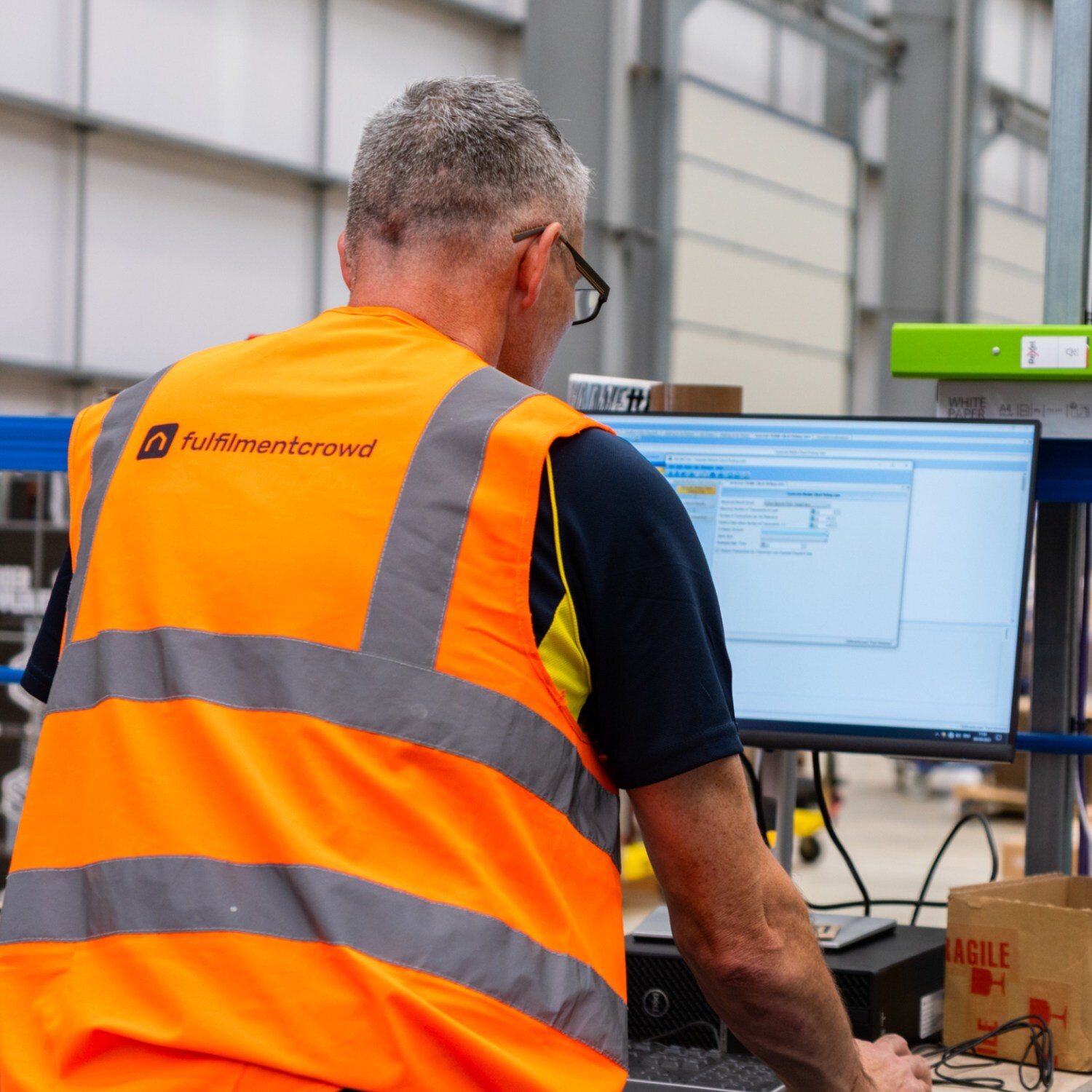 Warehouse worker using computer